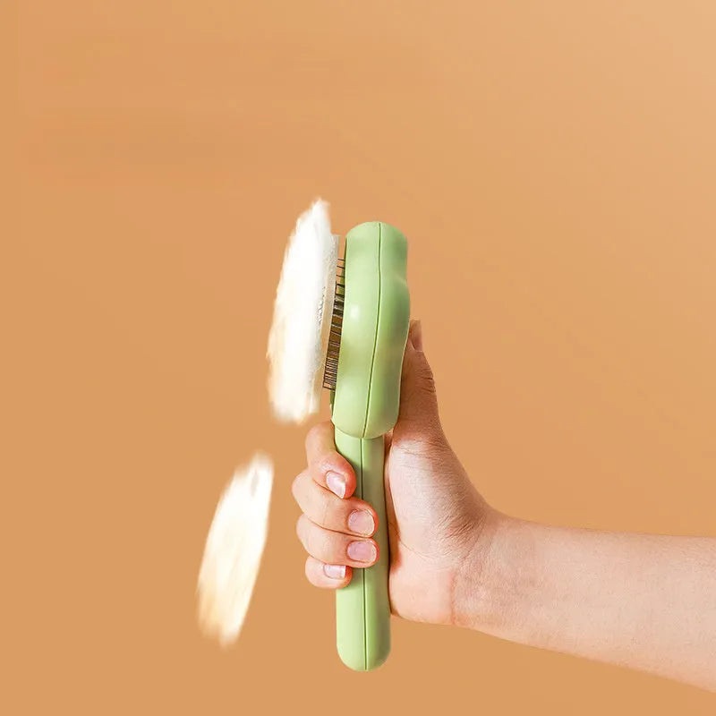 Green and yellow stainless steel self-cleaning cat comb for de-shedding, measuring 20cm.