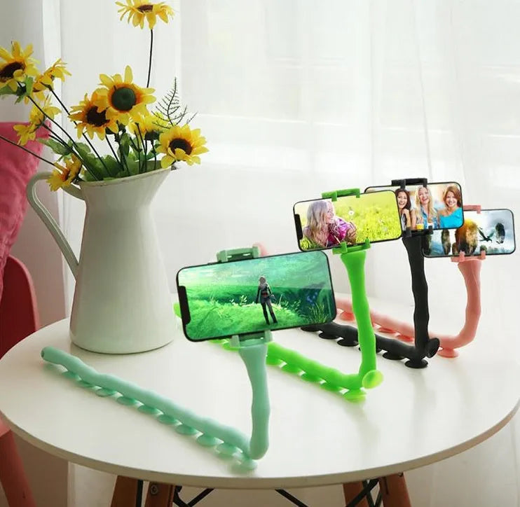 Black flexible rubber phone holder with suction cup bent into an S-shape, showing 360-degree rotation joint.