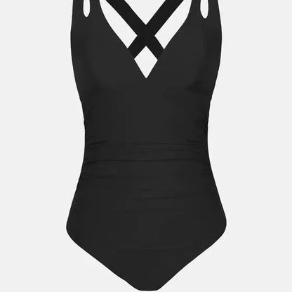 One-piece swimsuit with triangle bikini top and cross shoulder straps in solid colour