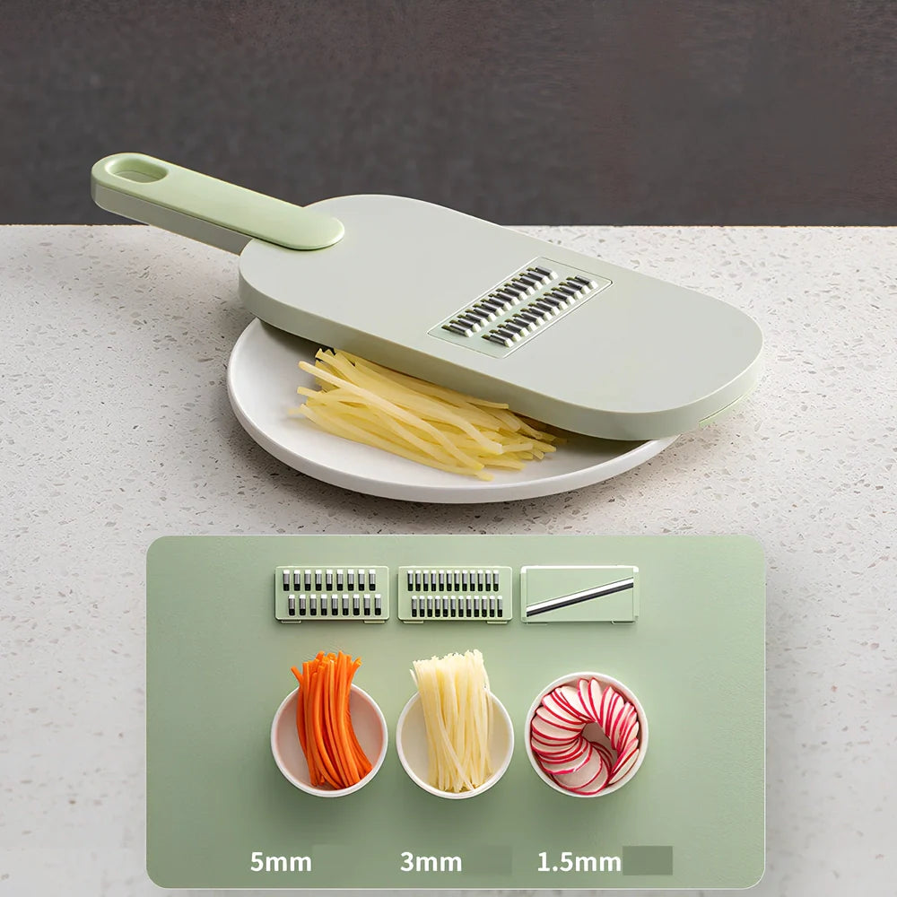 Shredded vegetable slicer with stainless steel blades on green cutting board
