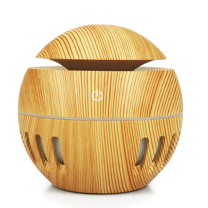Portable USB humidifier in dark wood, light wood or white with 1 litre water tank and single fog outlet.