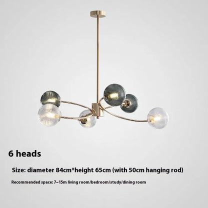 Modern Nordic-style chandelier with multiple green glass shades hanging at different heights.