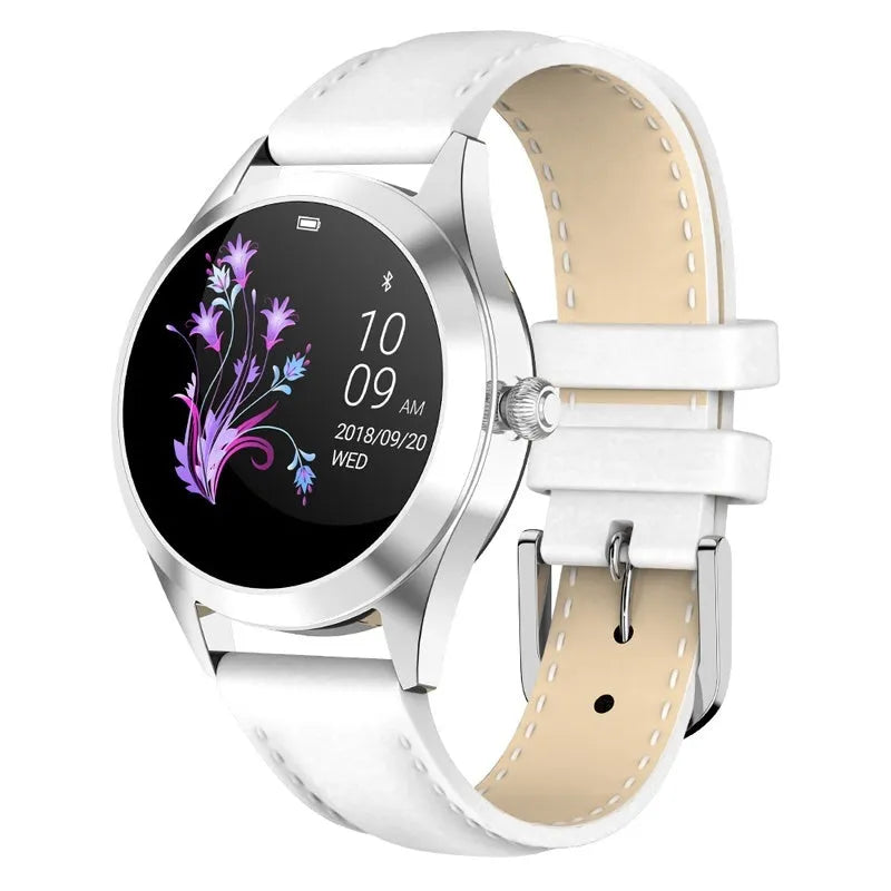 Women's sports smartwatch showing heart rate monitoring and available in black, rose gold, silver, or white colours.