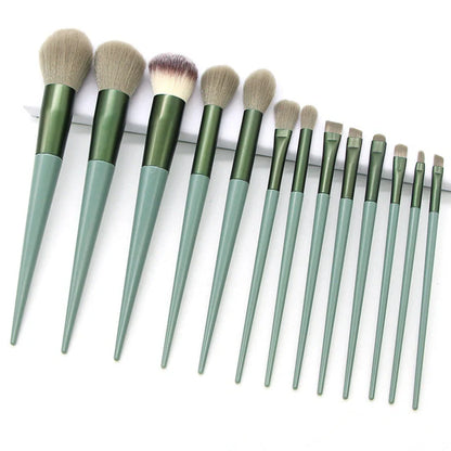 13 green makeup brushes with plastic handles and aluminium ferrules arranged with storage bag