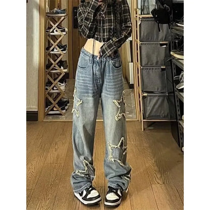 Blue high-waisted wide-leg denim trousers with a straight-leg cut on a model.