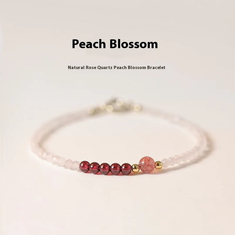 Handmade pink crystal bracelet with strawberry quartz charm showing 2mm beads