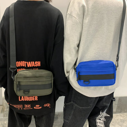 Men's street style nylon messenger bag in solid colour with sewing thread details and crossbody strap