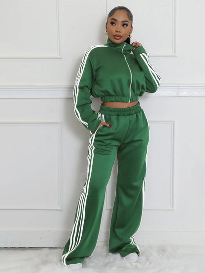 Woman wearing a grey striped zipper sweater and matching trousers from a casual two-piece set.