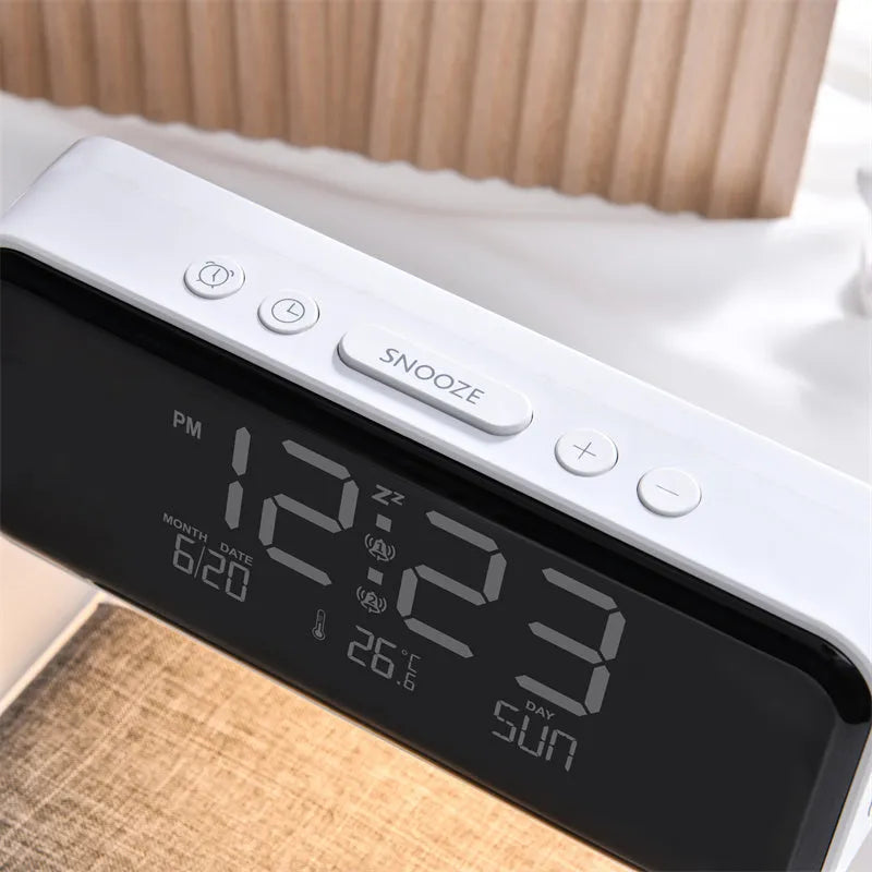 White 3-in-1 bedside lamp with wireless charging pad, LCD alarm clock screen, and touch controls.