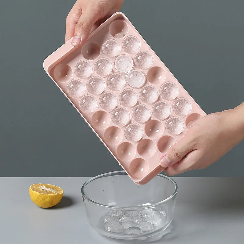 Sky blue and pink 3D round ice moulds creating spherical ice balls for drinks
