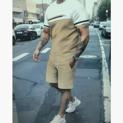 Man wearing a loose fit grey short-sleeved t-shirt and matching shorts from a summer leisure suit.