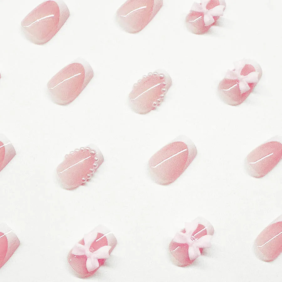 Fashion short white French cute bow manicure set with 24 nail art pieces including tulip, bow, starry sky, leopard print, and XINGX designs.