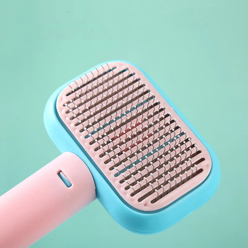 Premium pet hair brush and massage comb for cats and dogs in grey, pink, and green colors
