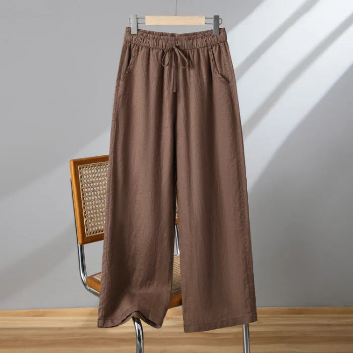 Women's apricot straight-leg casual trousers with elastic waist and drawstring lace-up detail.