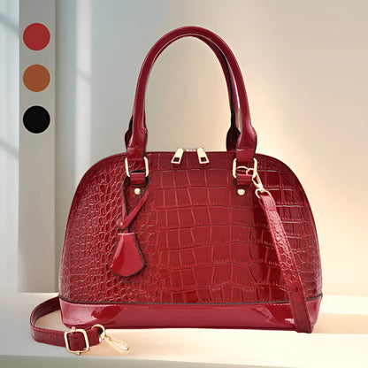 Large shiny black PU leather crossbody bag with a shell shape, shown from the front.