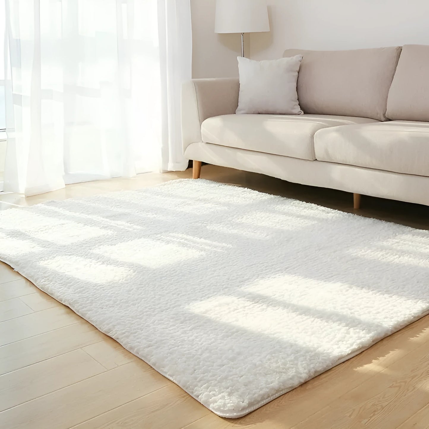 Solid colour plush rectangle area rug with soft texture on a wooden floor.