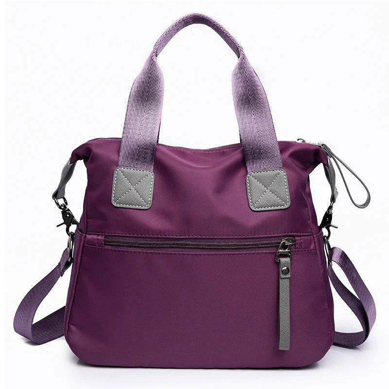 A fashionable and versatile ladies tote bag with multiple compartments and carrying options for the modern woman on the move.