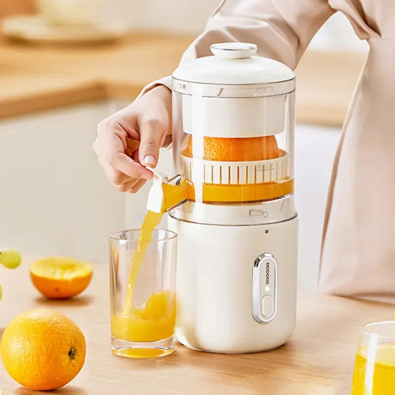 Fresh green portable USB electric juicer and blender for oranges and vegetables on a kitchen counter.
