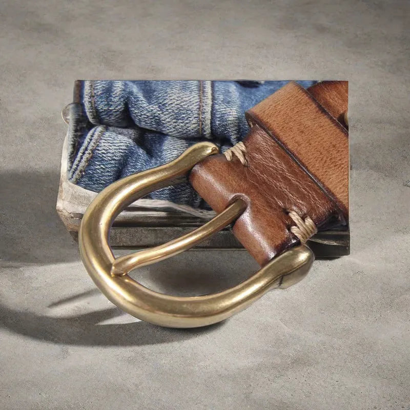 Men's black cattlehide leather jeans belt with a copper pin buckle shown on a flat surface.