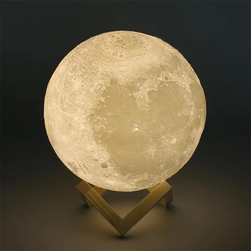 3D printed white moon lamp on a wooden holder, showing detailed crater texture and soft LED glow.