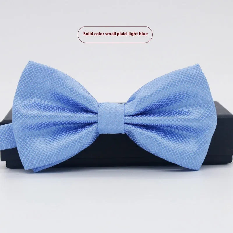 A solid colour pre-tied bow tie with an adjustable neck strap, shown in a classic flat head shape.