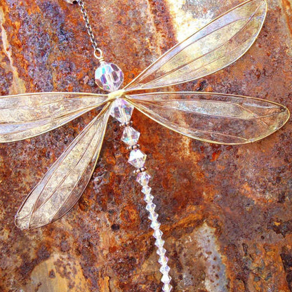Elegant dragonfly-shaped crystal suncatcher with vibrant rainbow reflections