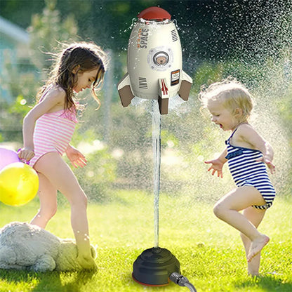 Yellow outdoor water pressure rocket launcher toy for kids on a green lawn.
