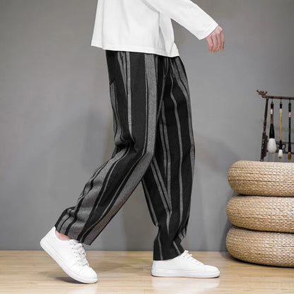 Navy blue and black striped men's casual trousers with a non-elastic waistband laid flat.