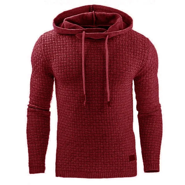 A man wearing a cotton-polyester blend hoodie available in nine colours including black, navy, and red.