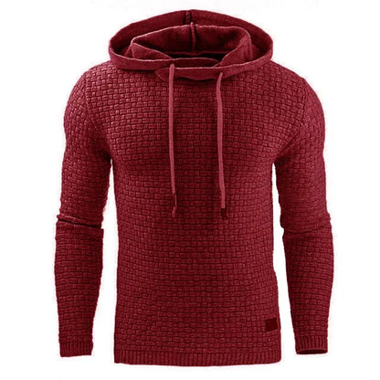 A man wearing a cotton-polyester blend hoodie available in nine colours including black, navy, and red.