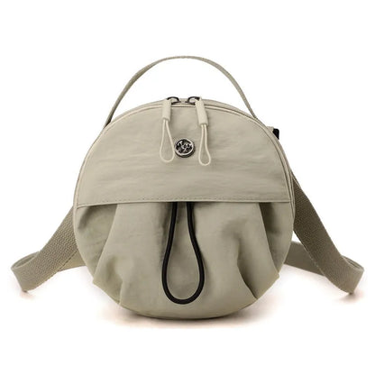 Out shoulder crossbody messenger bag in nylon showing interior zipped changing bag, phone pocket, and document compartment.