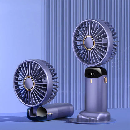 Blue foldable mini handheld electric fan showing its LED display and hanging lanyard.