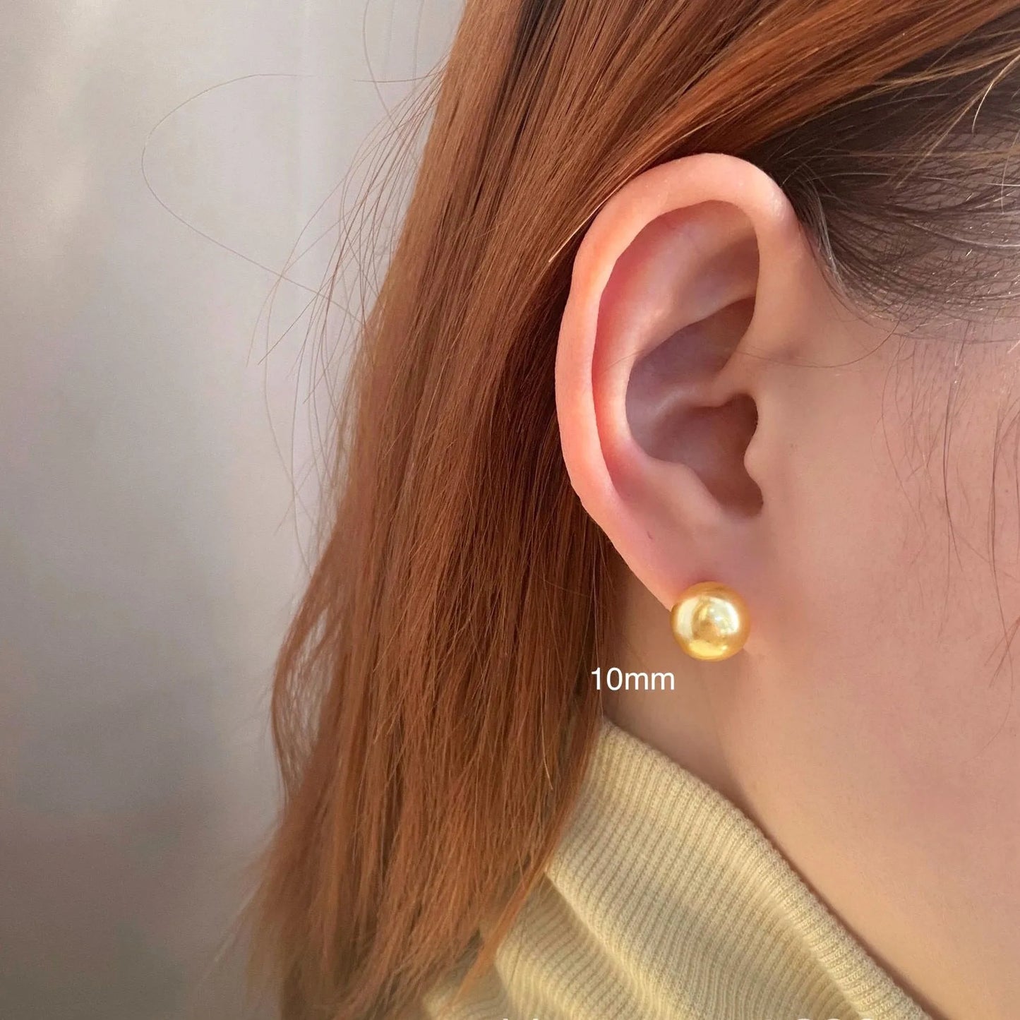 Geometric eight-point star pearl stud earrings in silver with cultured pearls, showing post-and-clasp fastening