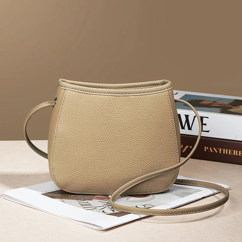 Women's genuine cowhide leather messenger bag showing organisational compartments and sandwich pockets in neutral colour