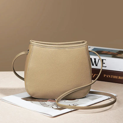 Women's genuine cowhide leather messenger bag showing organisational compartments and sandwich pockets in neutral colour