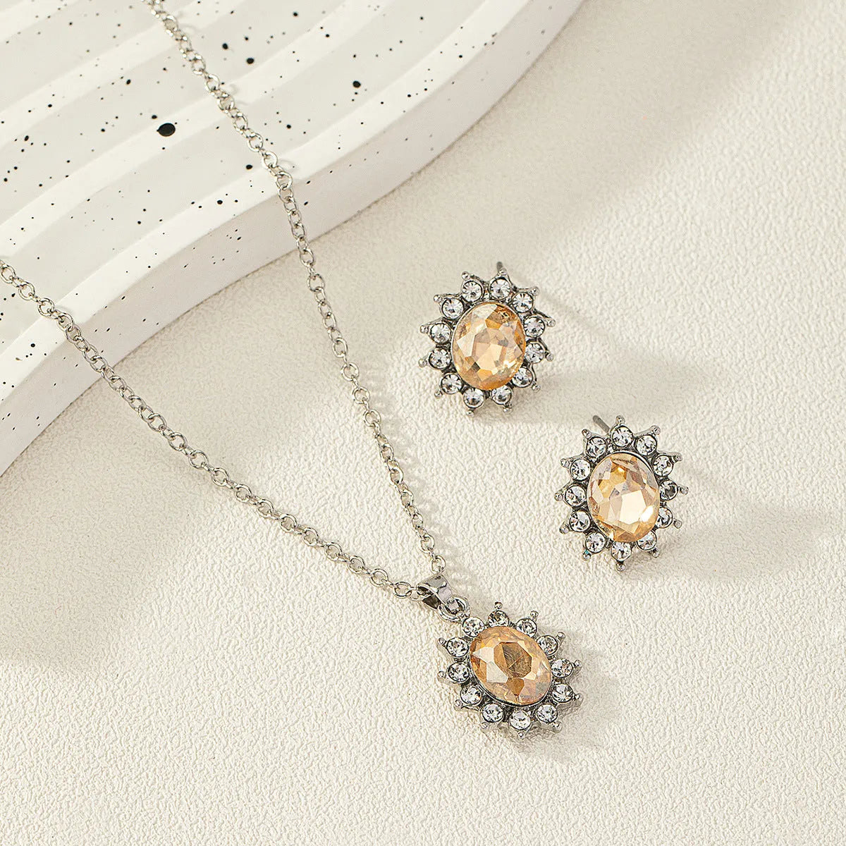 Sunflower zircon necklace and earring set in alloy with electroplated finish showing ellipse-shaped design