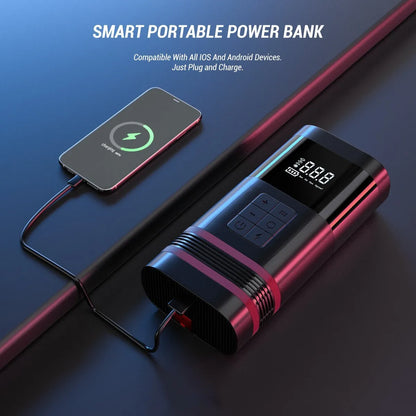 Black wireless portable 100W car jump starter power bank with jumper pins and charging cables on a table.