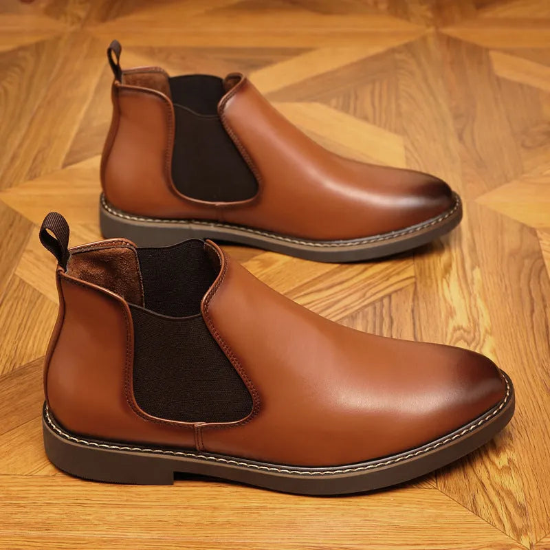 A pair of formal black leather pointed-toe boots with a square heel and rubber sole