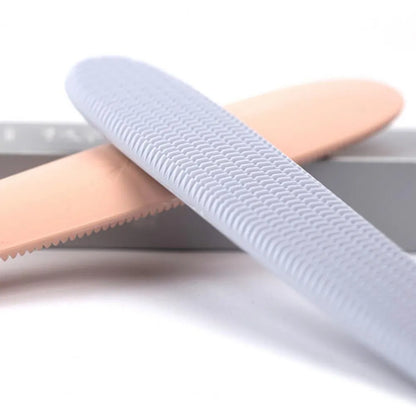 Grey and pink ABS plastic cat grooming comb with tongue-like texture and dual-ended design