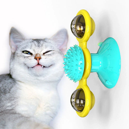 Cat playing with rotating windmill toy featuring luminous balls and suction base