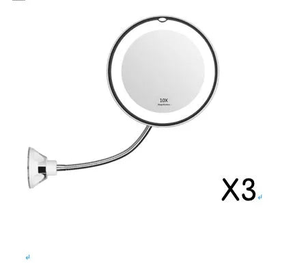 White 10x magnifying LED makeup mirror with flexible gooseneck and suction cup base on a table.