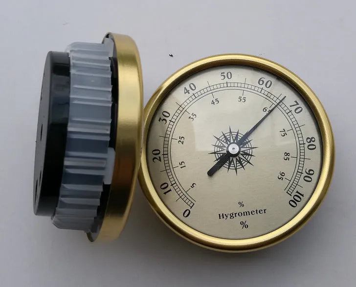 Analogue thermometer and hygrometer with aluminium outer ring and dial showing temperature and humidity scales