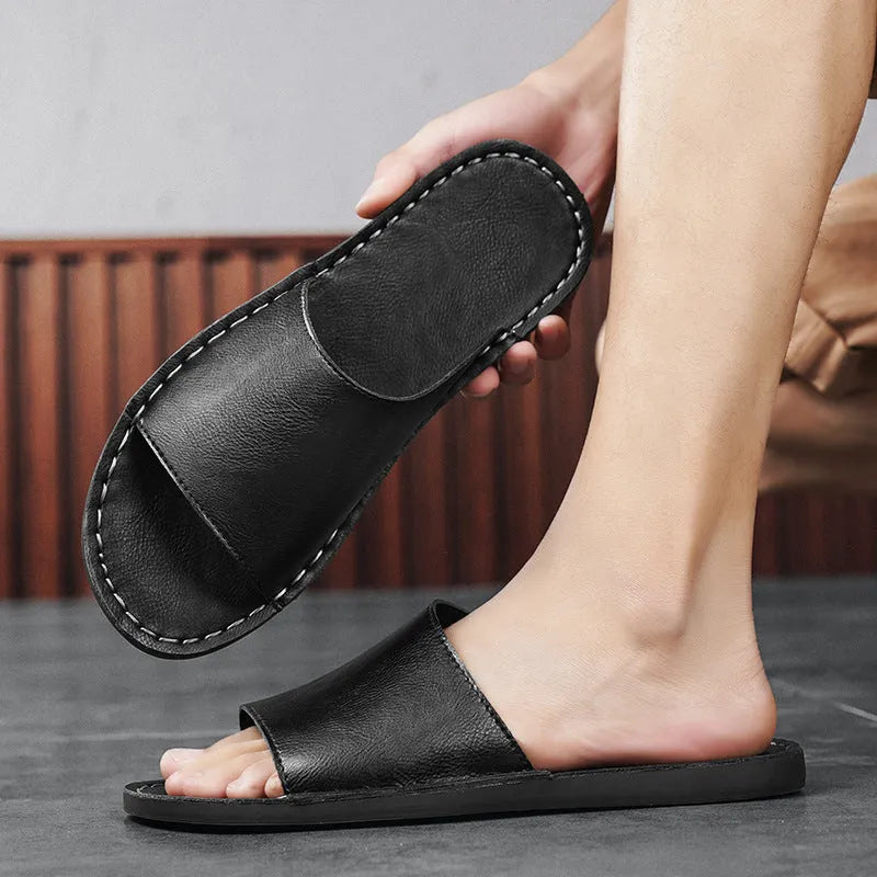 Brown leather men's sandals with a rubber sole on a neutral background