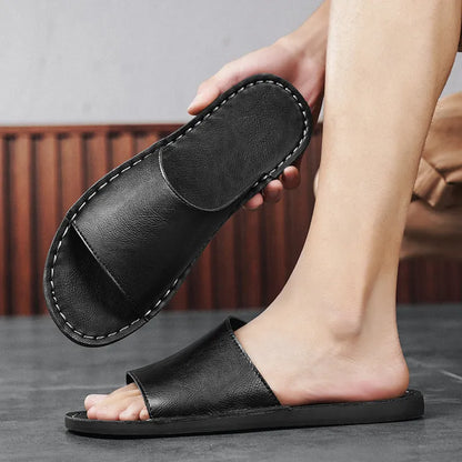 Brown leather men's sandals with a rubber sole on a neutral background