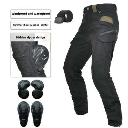 Motorcycle rider wearing green waterproof trousers with removable protective armour on knees and hips.