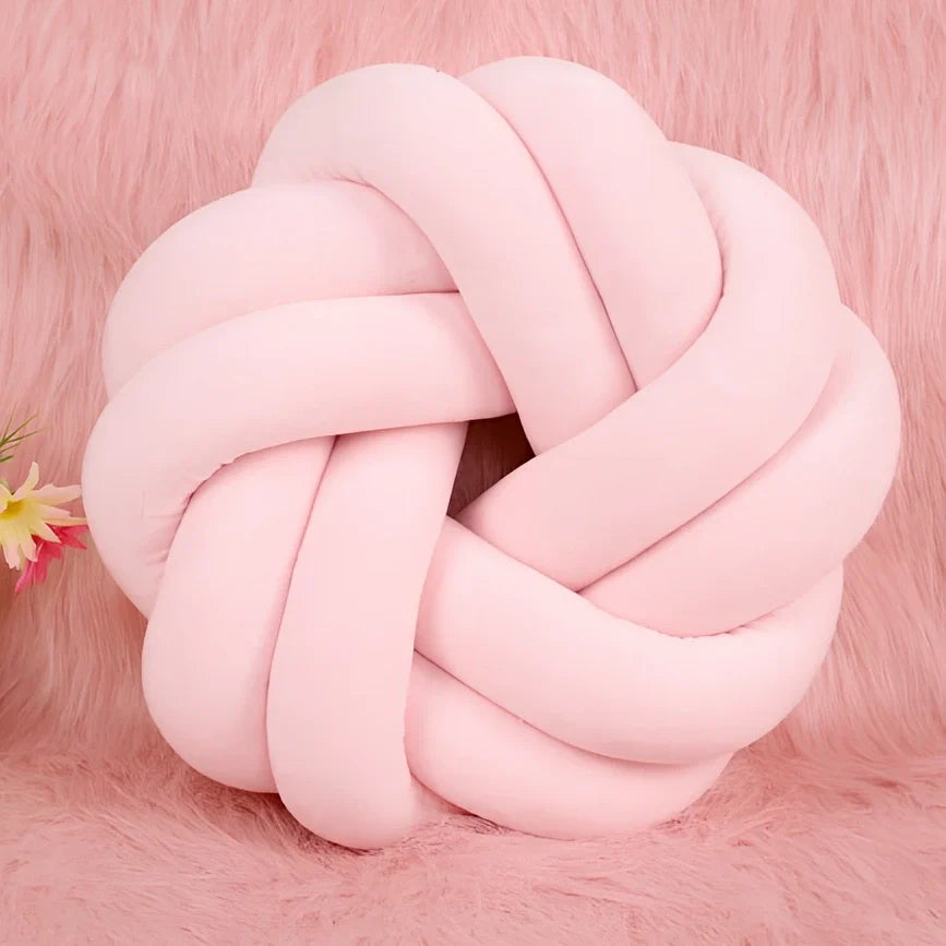 Knotted lumbar pillow with memory foam fill showing adjustable height feature and polyester cover