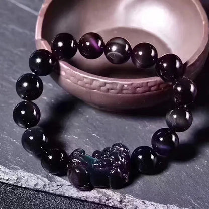 Natural Ice Colour Eye Obsidian crystal bracelet on wrist, showing translucent beads.