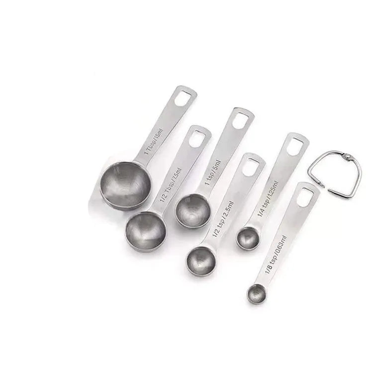 Set of six stainless steel measuring spoons connected by a silver D-ring, showing engraved measurement markings