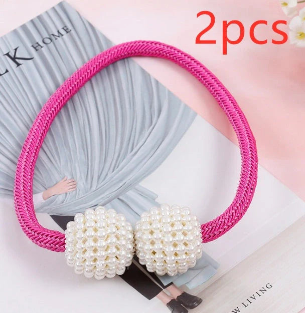 Magnetic curtain tiebacks with white pearl beads and fabric loops holding gathered curtain