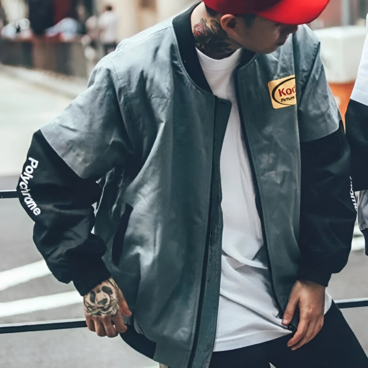 Hip hop style baseball jacket in grey or white with streetwear print, round neck, and side slit pockets.